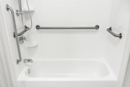 A white bathroom featuring a bathtub, shower fixtures, horizontal grab bars on three sides, and a small corner shelf.