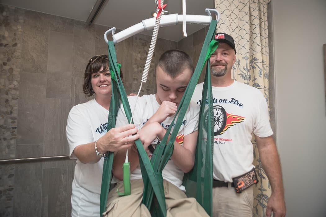 Parents Martie (left), Conrad (right) take a picture with Connor (center)
