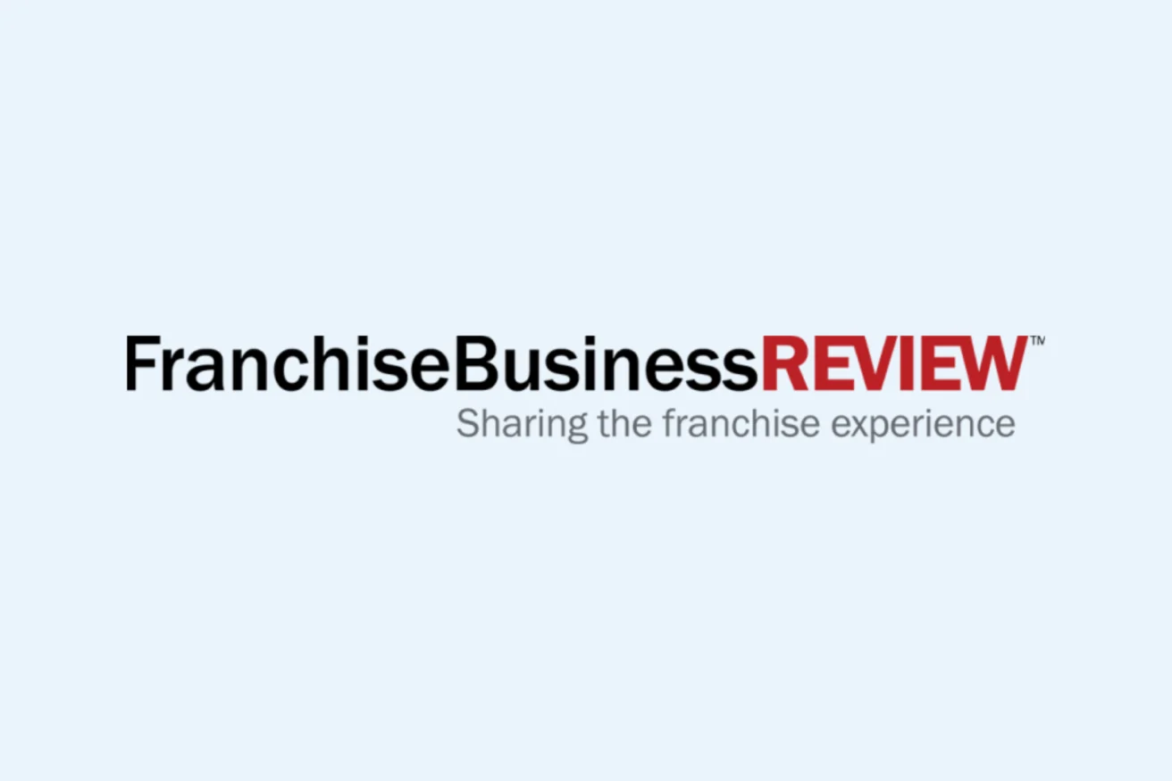 Logo of Franchise Business Review with the tagline "Sharing the franchise experience" against a light grey background.