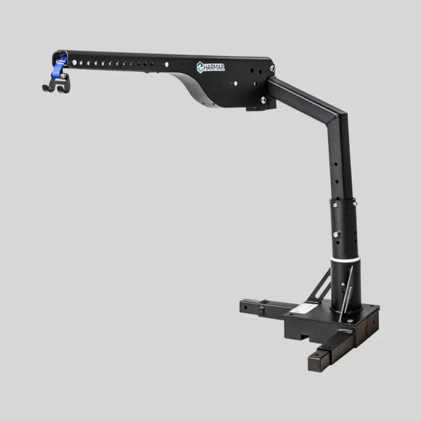 A black HamrA reacher/loader crane with a hook attachment, mounted on a base, viewed on a neutral background.