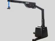 A black mechanical lift with a blue nylon strap and hook attachment for lifting objects, set against a plain gray background.