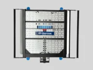 A Harmar vehicle lift platform for wheelchairs, featuring a silver metal surface with star-shaped cutouts and black frames on the sides.