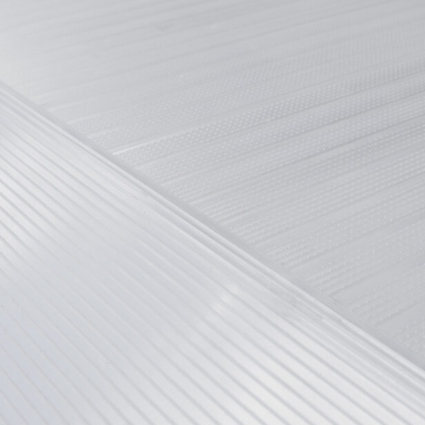 Close-up of a textured white surface with diagonal and parallel lines creating a patterned design. The image showcases the fine details and textures of the surface.
