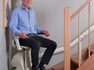 a man using a Handicare Freecurve Curved Stairlift.