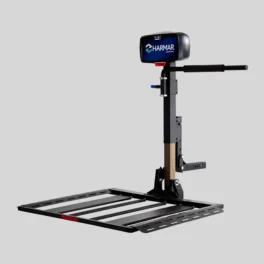 Image of a Harmar vehicle lift, designed for transporting mobility devices. It features a platform with slats, a vertical post, and a control box labeled with the Harmar logo.
