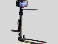 A motorized mobility lift with Harmar branding for transporting wheelchairs or scooters, featuring a platform, control box, and mounting brackets.