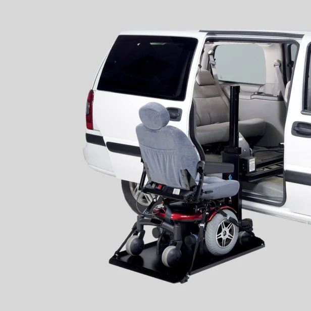 A white van with an open side door and an automated lift holding a motorized wheelchair, positioned for easy access.