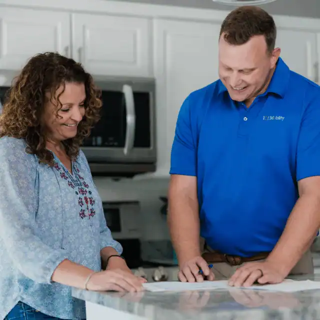 a 101 mobility staff member showing a customer paperwork.