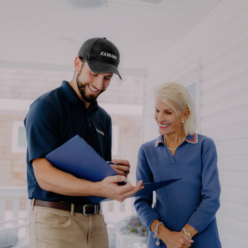 a 101 mobility staff member showing a customer paperwork.