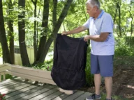 a man covering up a bruno elite outdoor curved stairlift.