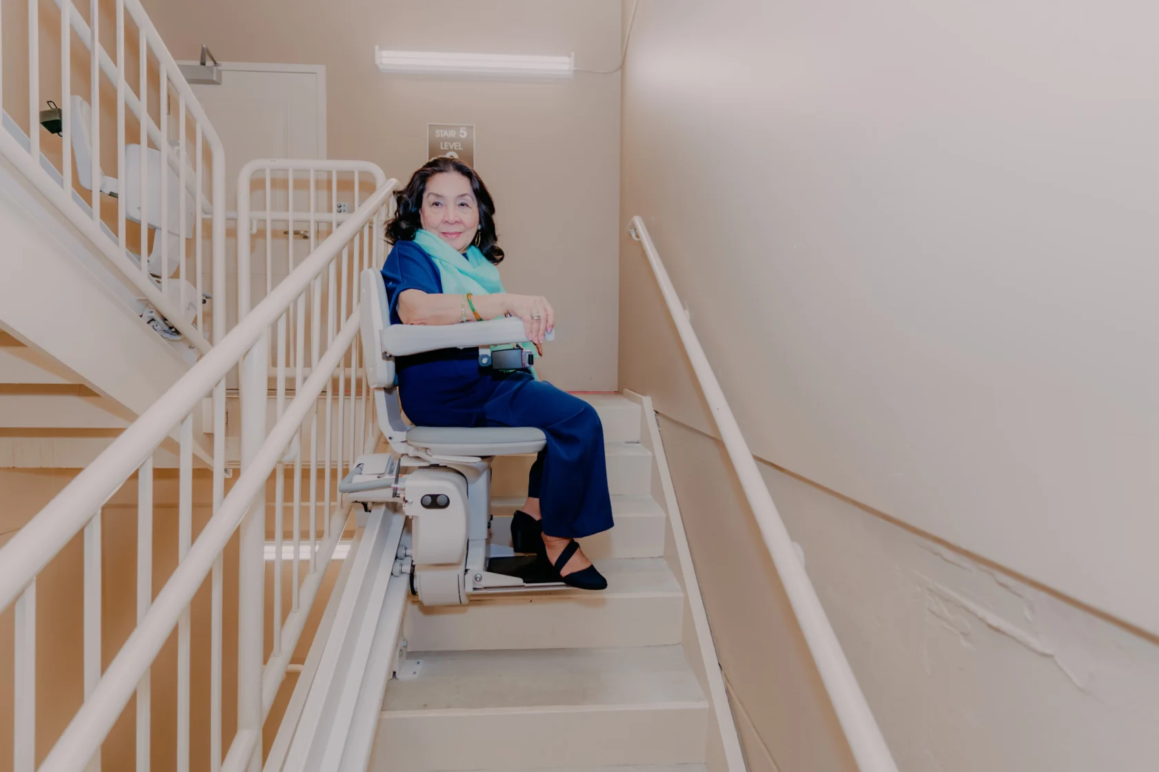 a woman using a stairlift.