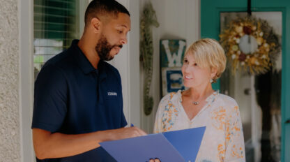 A 101 mobility team member having a conversation with a person.