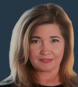 A woman with shoulder-length blonde hair and light skin is facing the camera against a dark blue background.