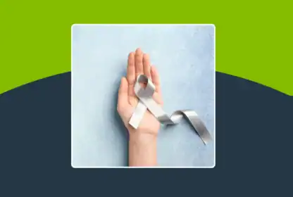 A hand is shown holding a gray awareness ribbon against a light blue background with a green and dark blue border.