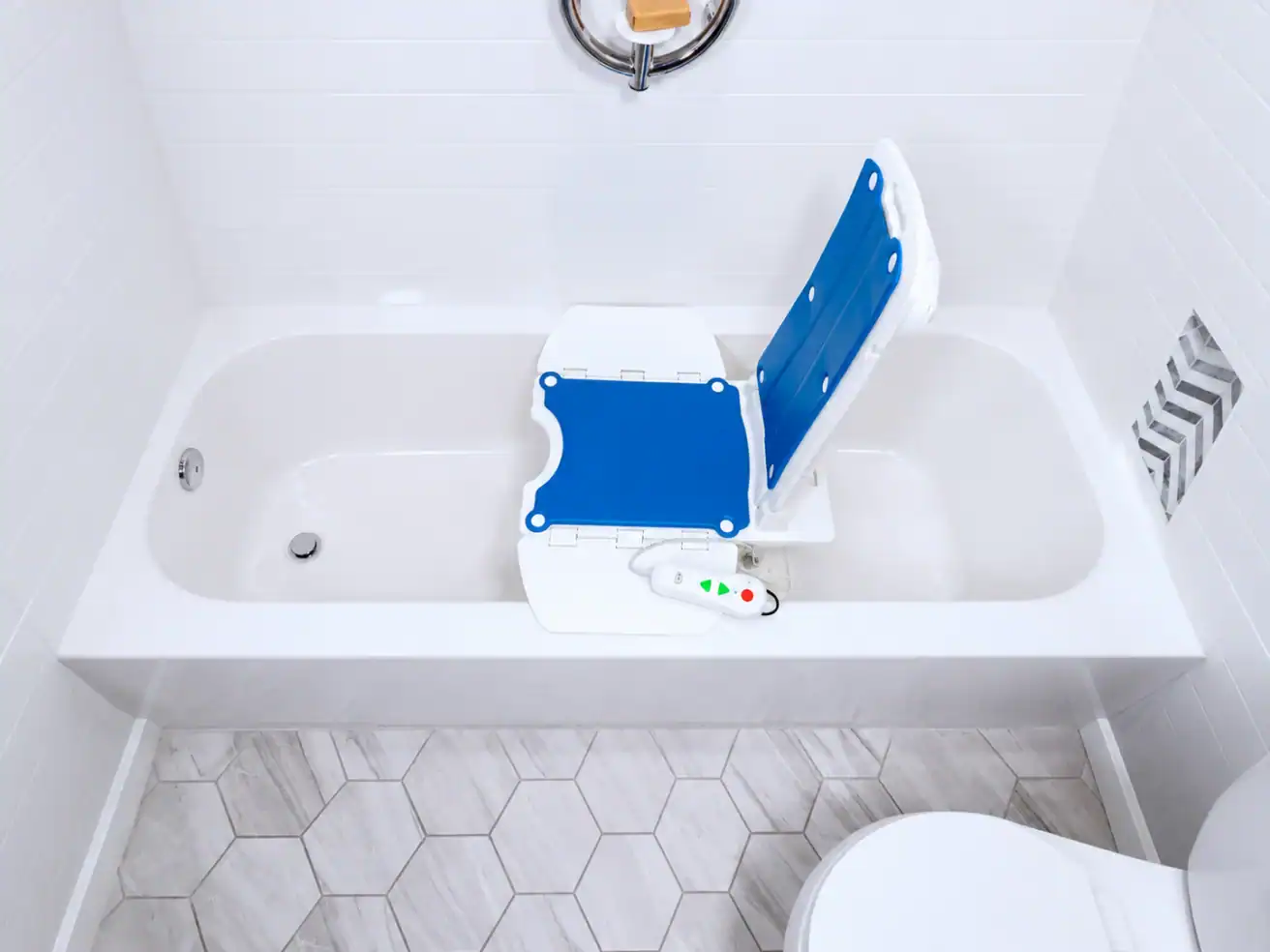 A bathtub with a blue and white bath lift chair and a remote control, designed to assist people with limited mobility.
