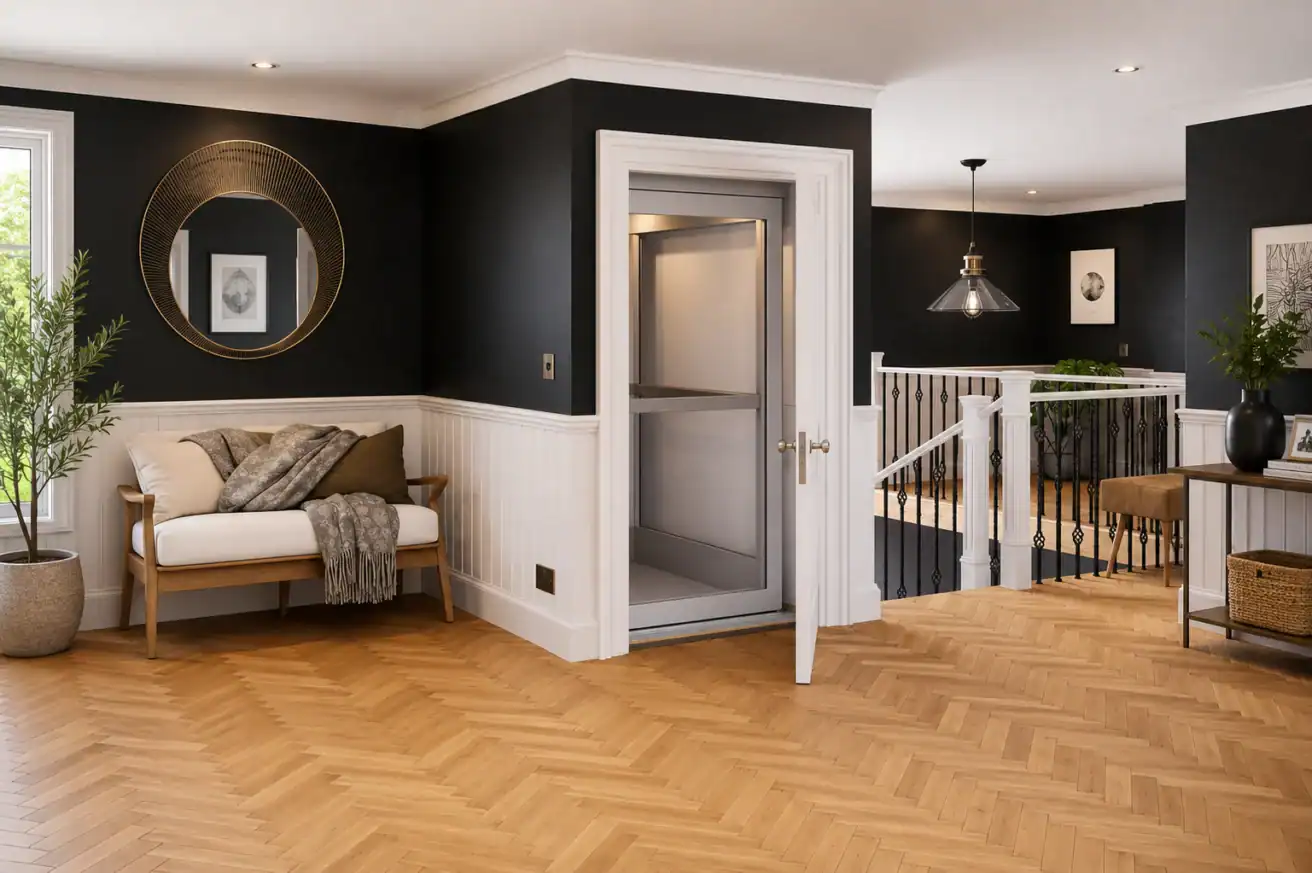Modern, well-lit hallway with black and white walls, wood herringbone floors, a home elevator, a bench with pillows, a round mirror, plants, and a staircase with white railings.