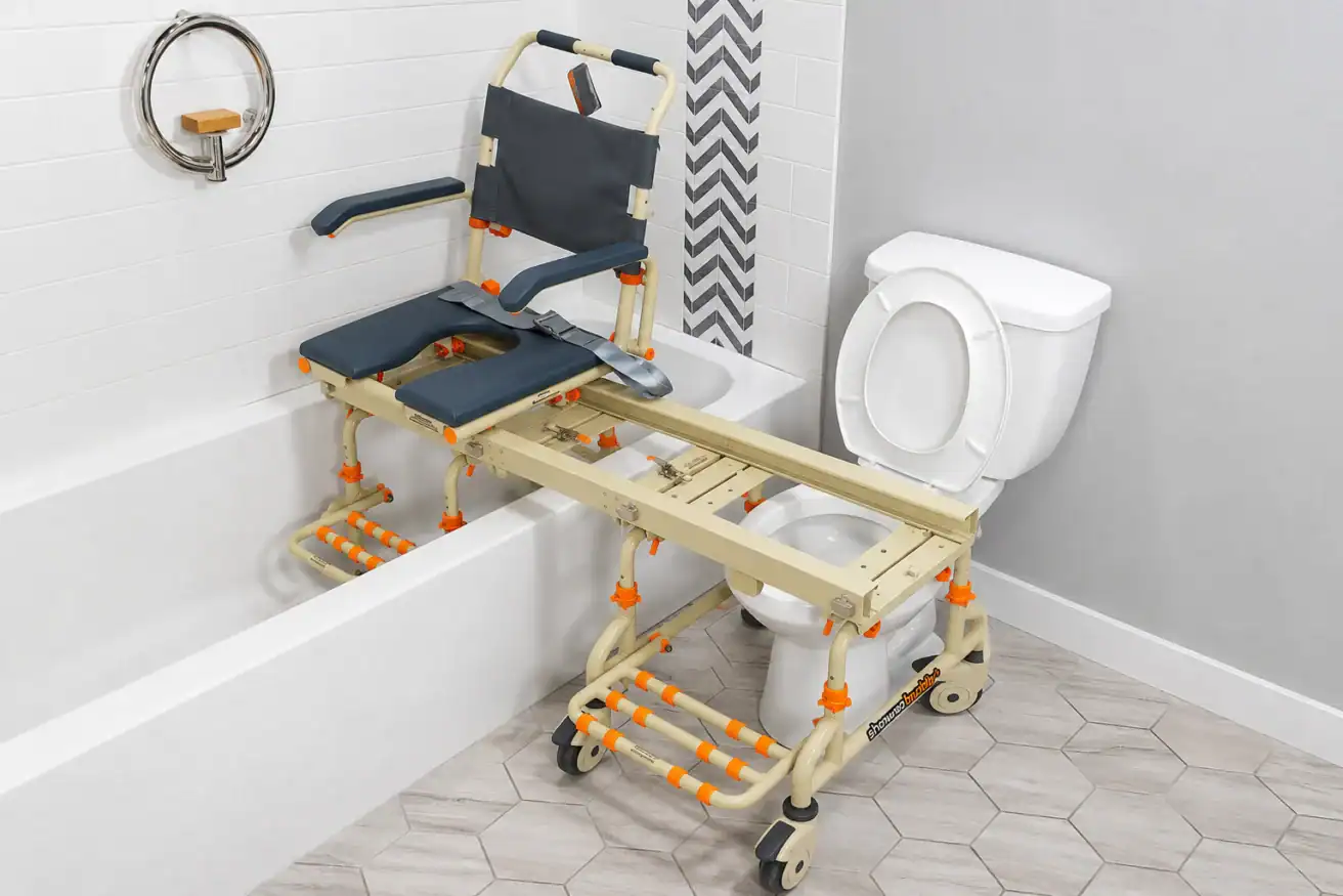Adjustable transfer chair spans a bathtub and toilet, allowing easy movement for individuals with mobility needs; features wheels, armrests, and cut-out seat.