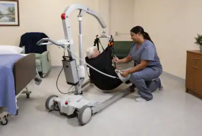 A healthcare worker uses a mechanical lift to assist an older adult from a hospital bed, ensuring safe patient transfer in a medical facility.