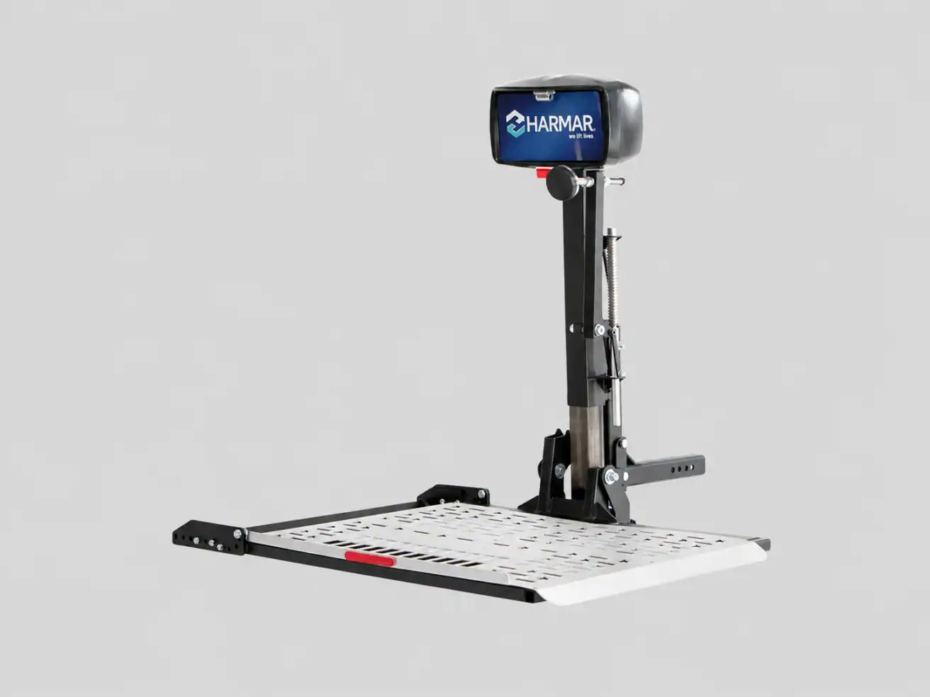 Platform lift with a black vertical support labeled “Harmar,” designed for mobility devices, shown against a plain gray background.