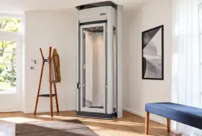 A Stiltz residential home elevator installed in a brightly lit room.